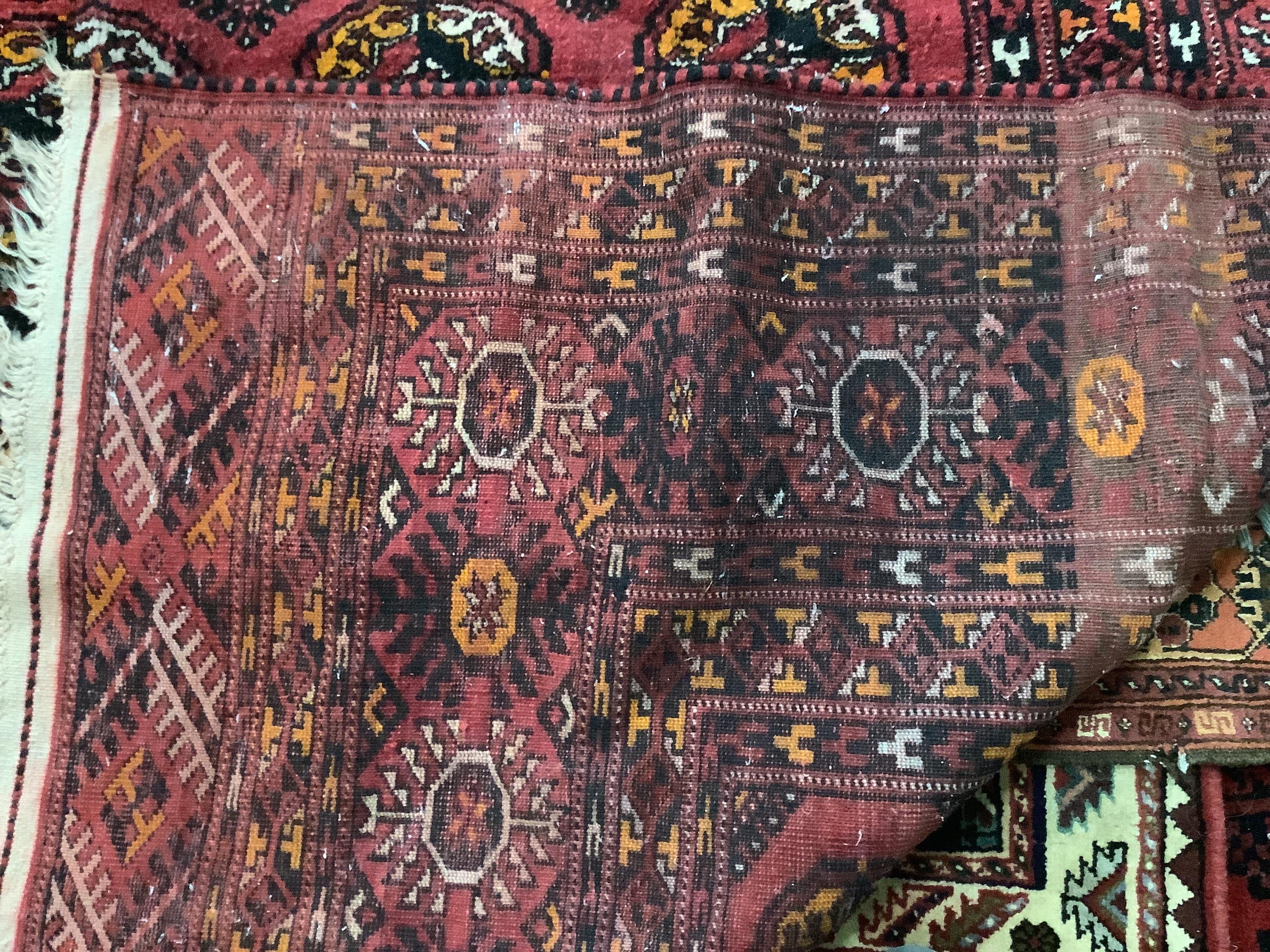 A Persian Bokhara design carpet, 403 x 225cm